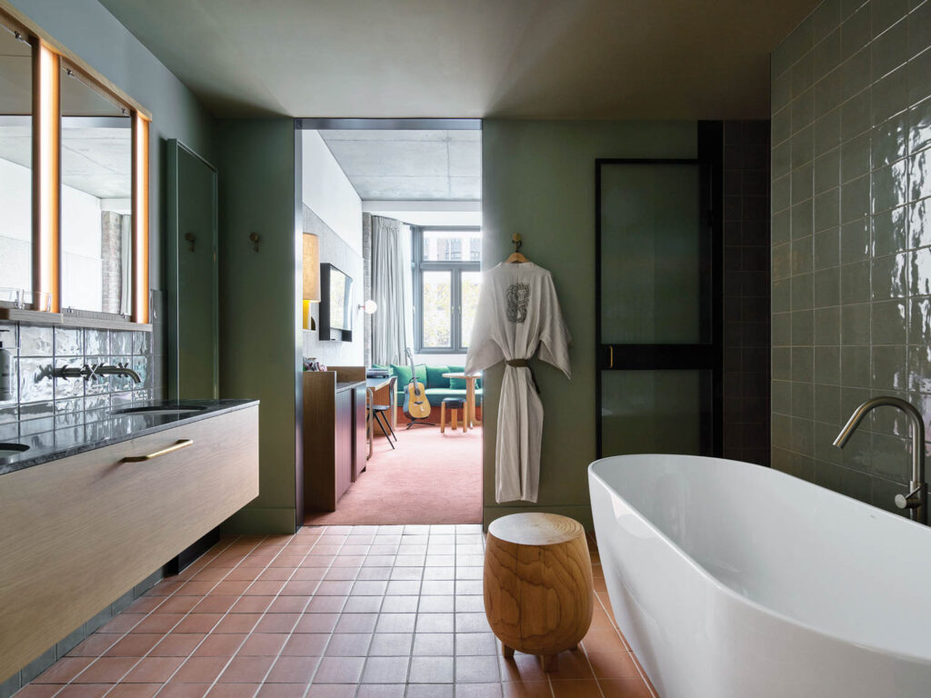 Terra-cotta floor tiles are complemented by a custom vanity of oak and honed Italian marble in another bathroom.