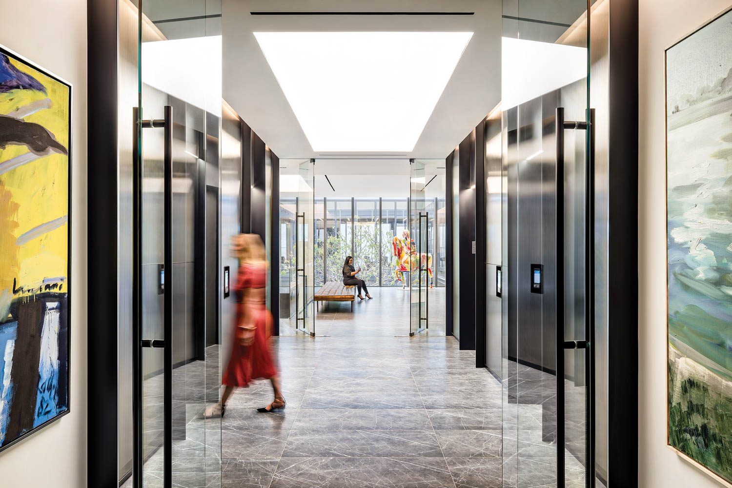 Porcelain tile flooring and a stretch fabric–like LED ceiling, materials used throughout, outfit the eighth-floor elevator lobby.