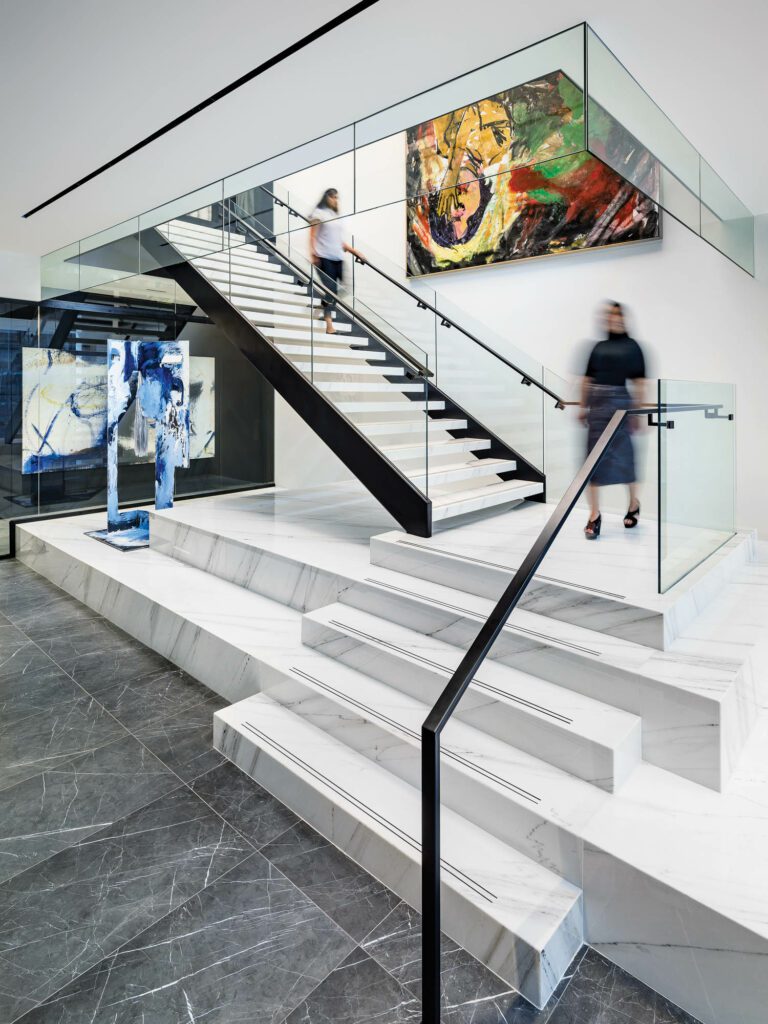 Italian marble forms the grand staircase, which also functions as a platform for a rotating display of artworks, such as Donna Huanca’s sculpture Cliona Chilenis on the left.