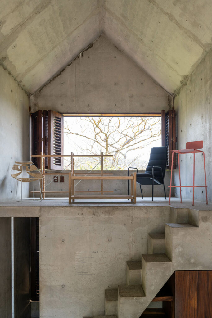 Most of Casa Tiny’s interior is concrete. The furniture, from left, is the wicker Faces chair by Edgar Orlaineta, Capicua bookshelves and Palma table by Marc Morro, and the black Crocodile chair and pink Jawad stool by Elias and Yousef Anastas.