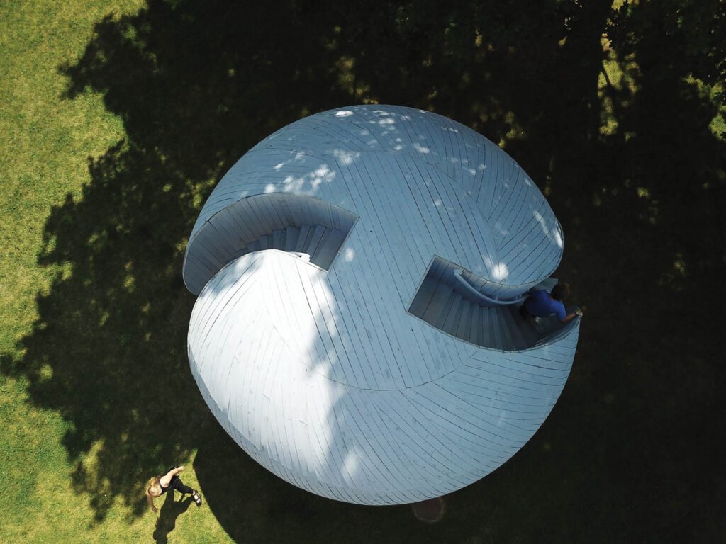 a man walks down the circular structure by Randi Renate