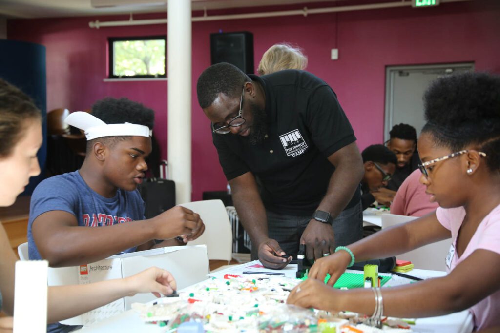 Michael Ford works with students on building a design module. 