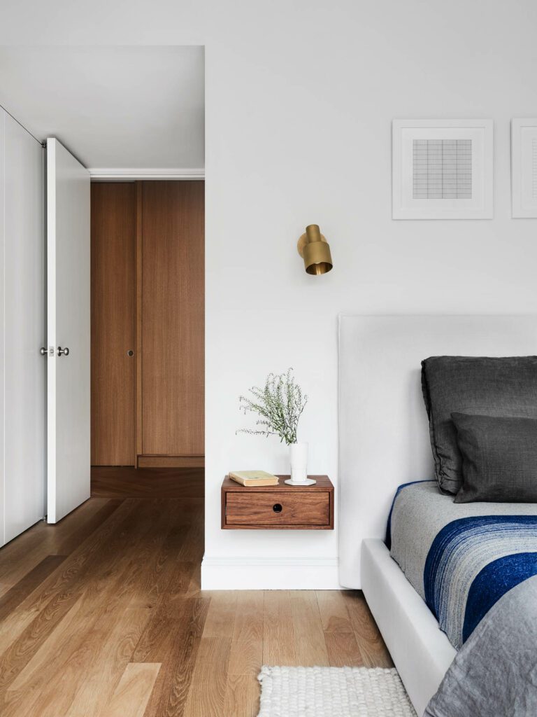 In the main bedroom, Allied Maker sconces shine upon Krovel Made walnut night stands and a Maiden Home.