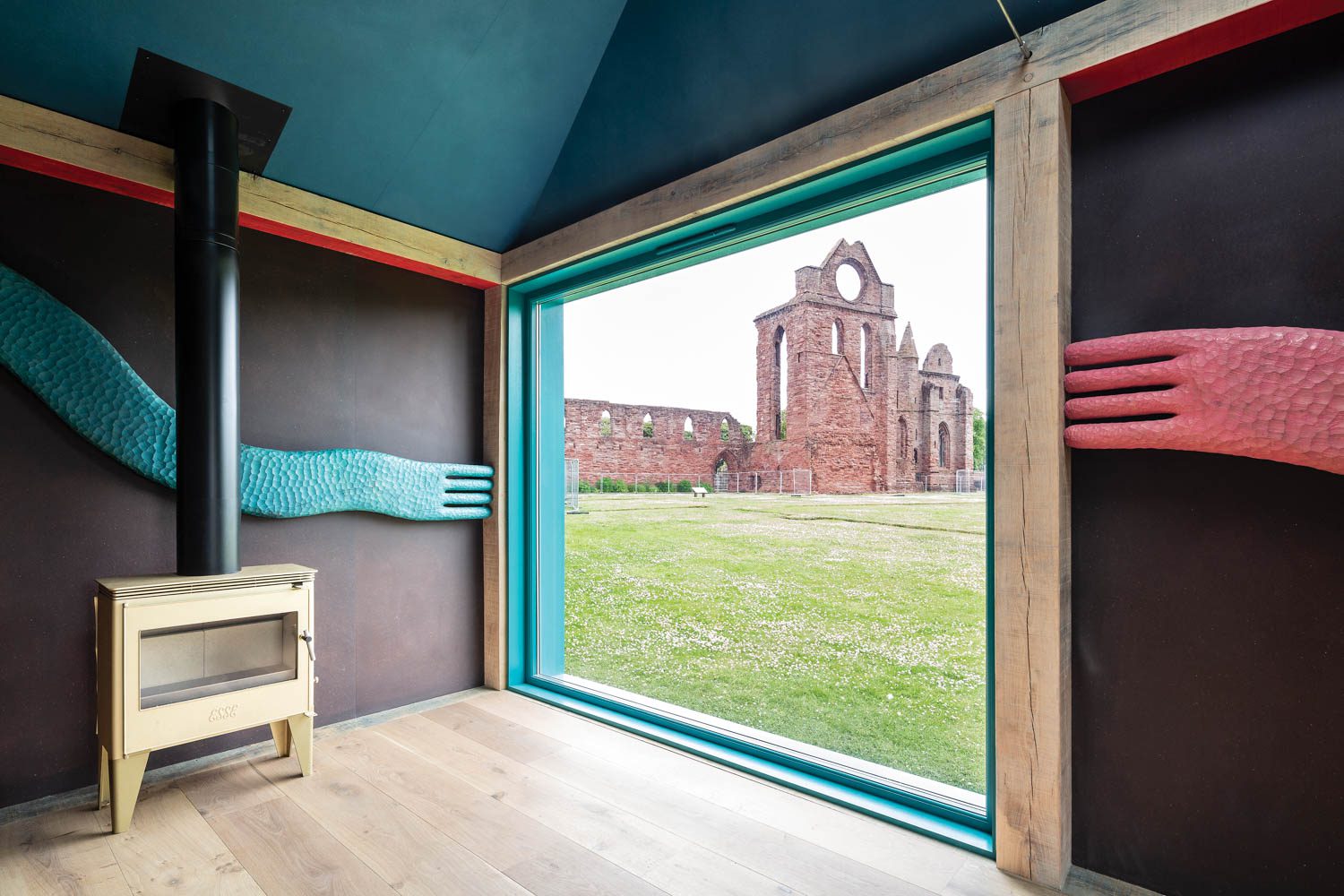 the one-room interior of the Scriptorium looking out into an open field and castle