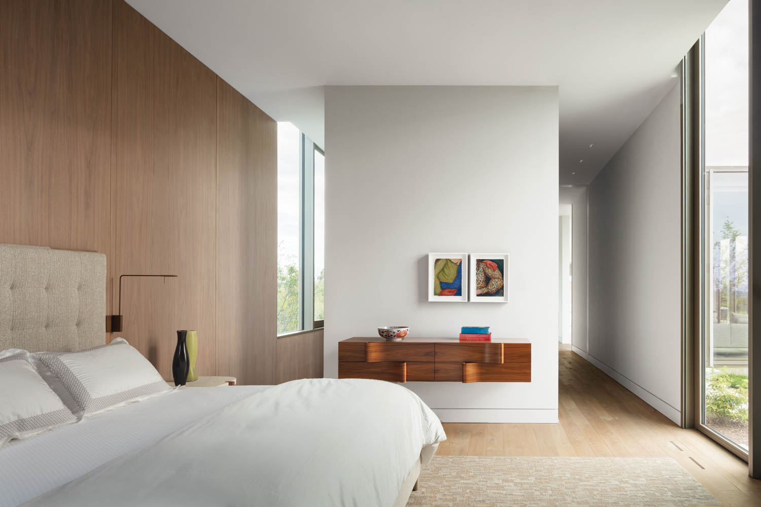 the bedroom with natural light and white accents