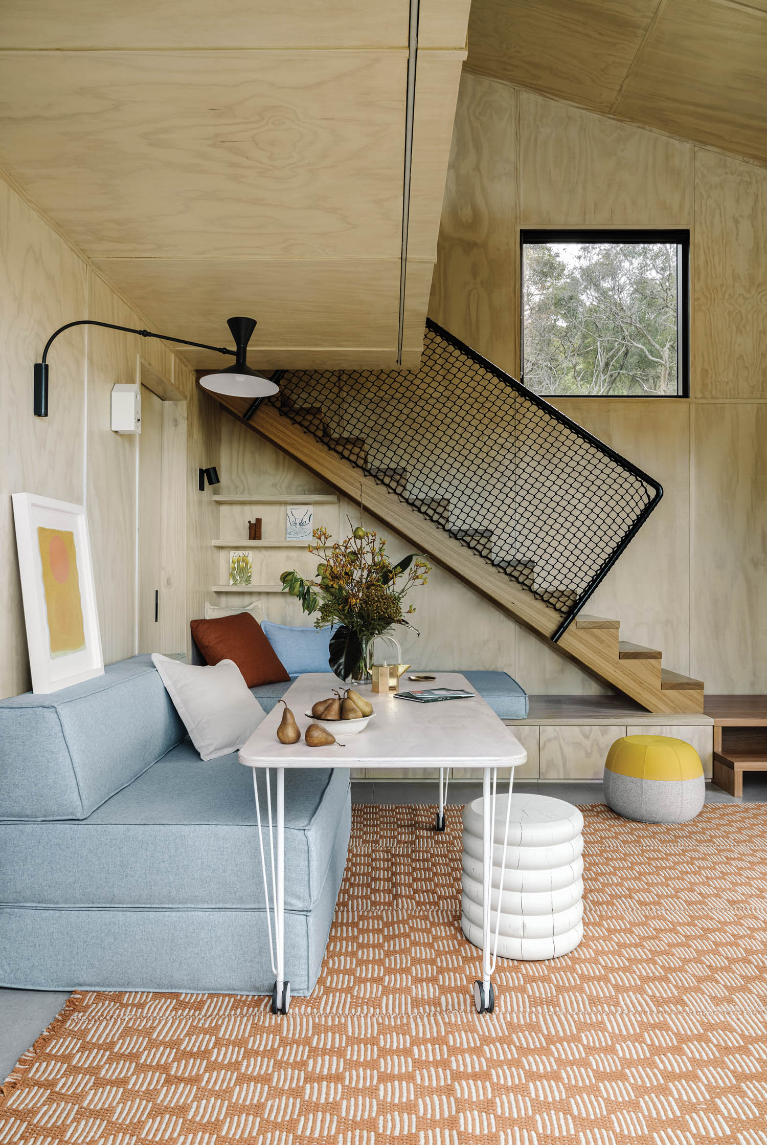 the seating area of the living room with blue sofa