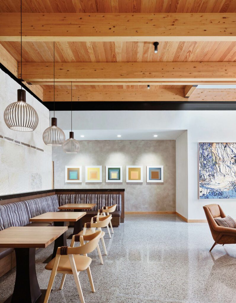 Art over­looks custom banquettes and tables and Patricia Urquiola’s Mathilda chairs in the pre-function area of the main building