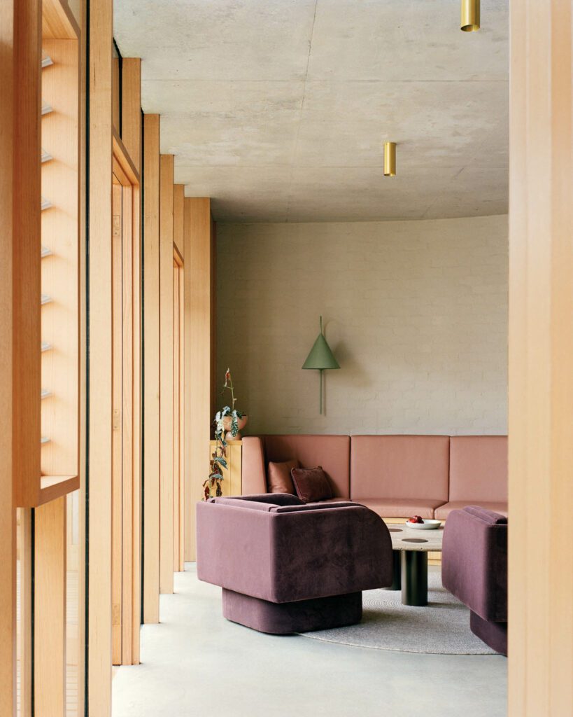 Located in one of two wings newly added to a century-old Victorian terrace house, the lounge features velvet-upholstered custom swivel chairs and a custom leather banquette.