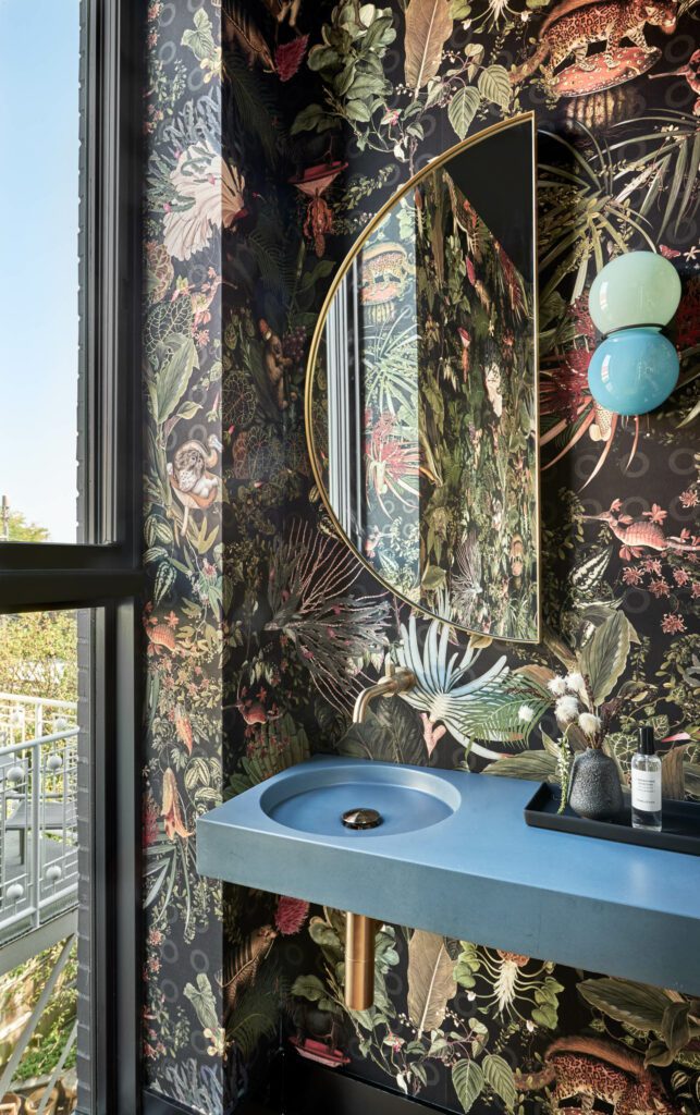 The walls of the third floor powder room are covered in Arte Moooi wallcovering