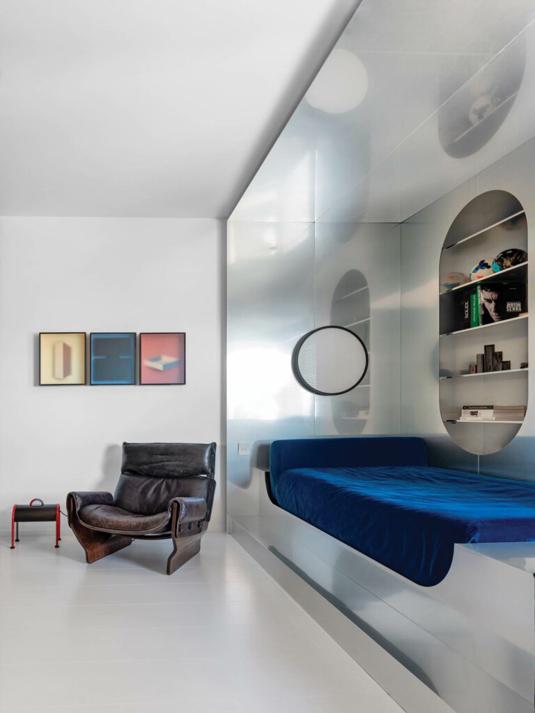 The son’s room features works by artist Alfredo Maiorino, a leather armchair by Osvaldo Borsani, and a custom aluminum-enclosed bed.