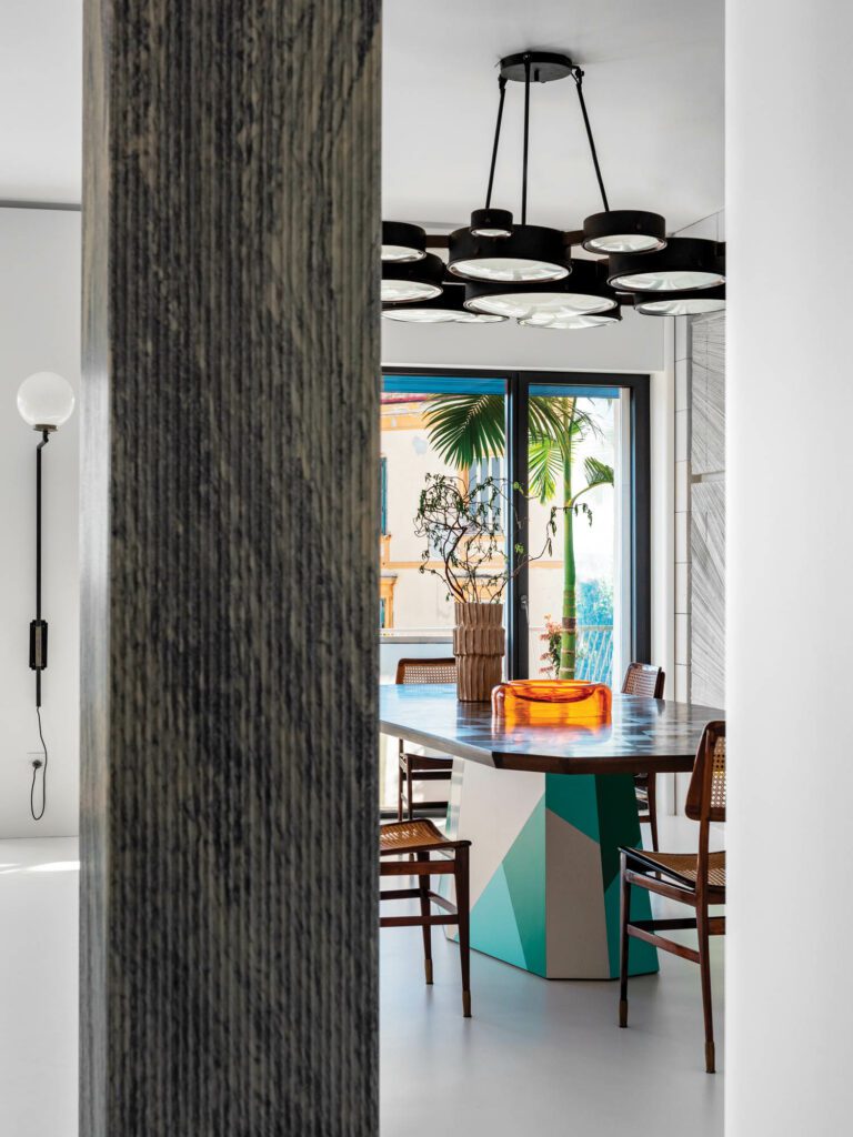 A BBPR lighting fixture from the 1960s hovers above the dining area’s custom walnut-topped Formica table by Martino Gamper.