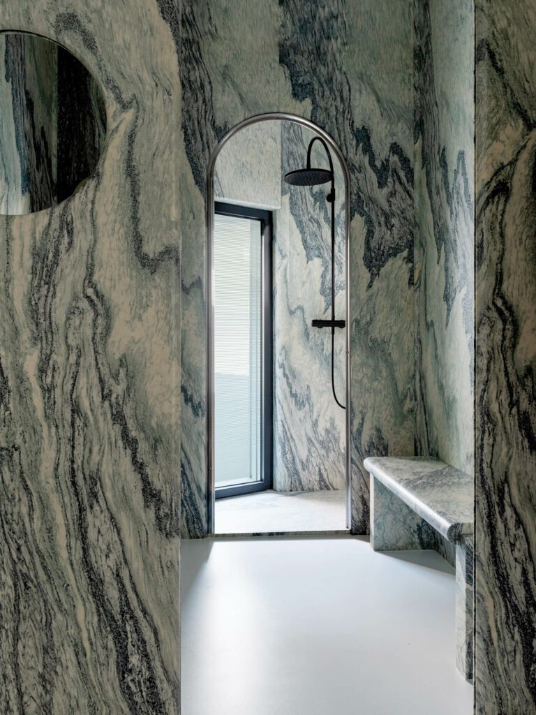 The primary bathroom is clad in heavily figured cipollino marble, quarried in northern Italy.