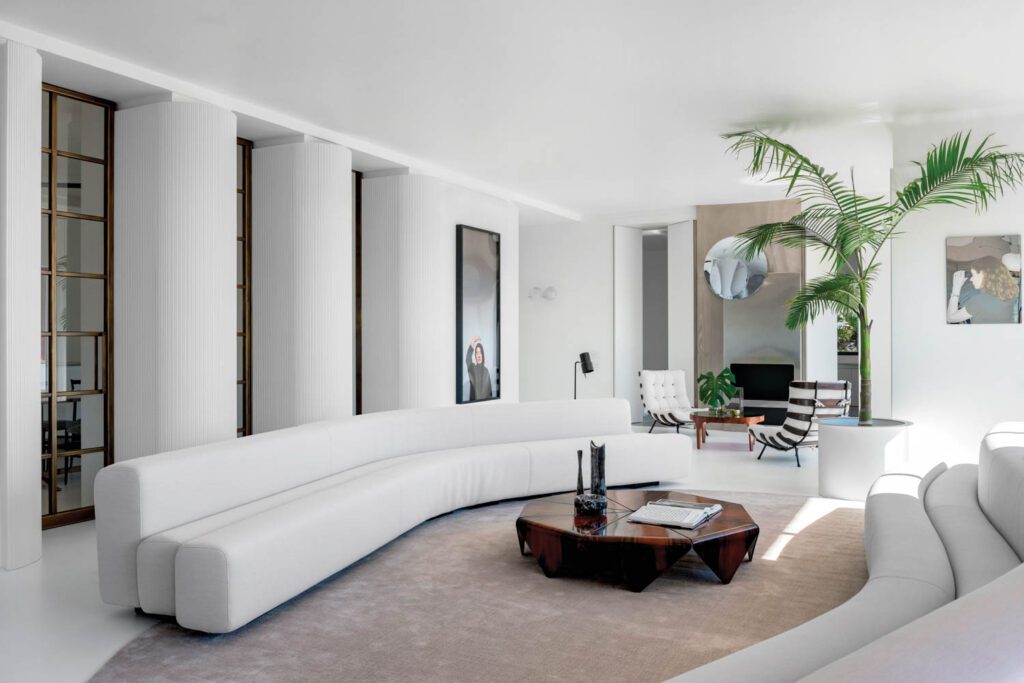 In the living area, a pair of Pierre Paulin Osaka sofas bracket a vintage Jorge Zalszupin origami-like Petalas table accented with Gio Ponti vases; the armchairs at rear are by Martin Eisler and Carlo Hauner. 