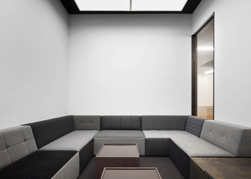 Custom tables in another meeting room are stained plywood with dark-glass tops that double as dry-erase boards.