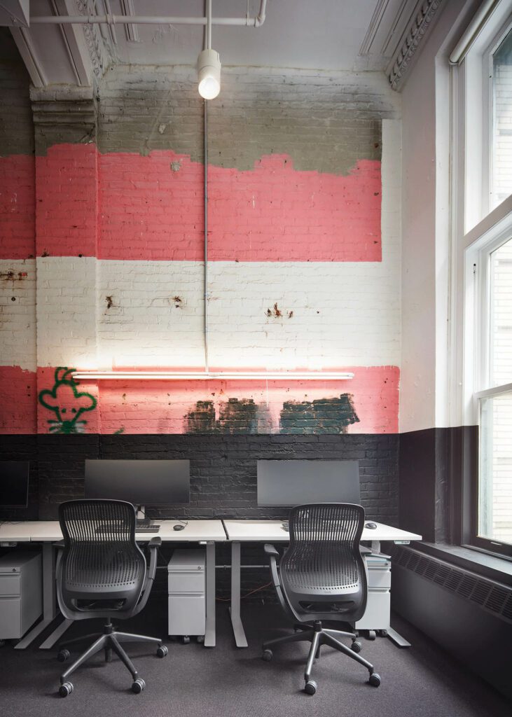 An office’s exposed brick wall with original graffiti found during construction.