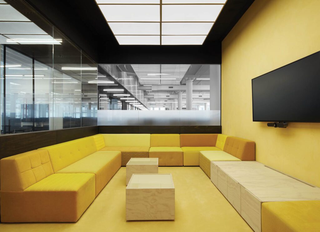 a room filled with yellow modular seating