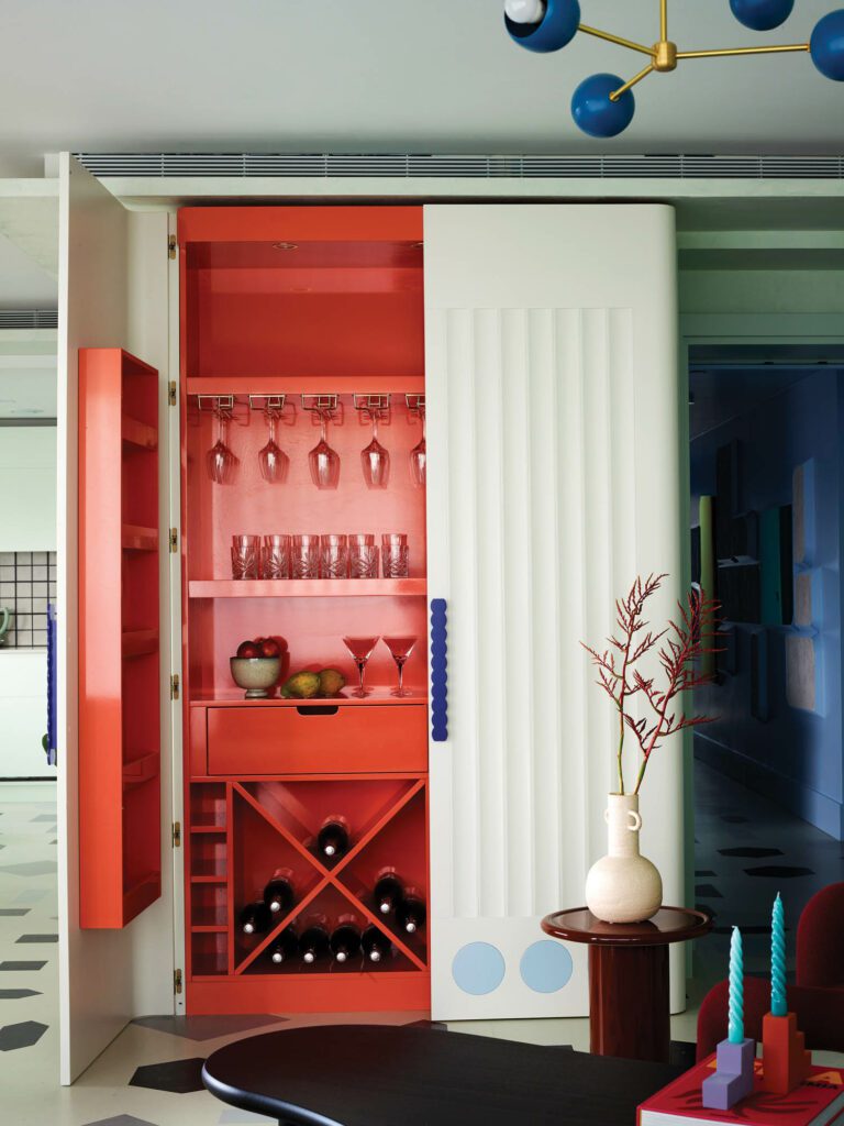 In the living room, a built-in bar with fluted MDF doors is unmissable when open yet disappears after last call.