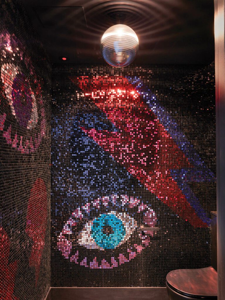 A WC offers a shimmering tribute to Bowie, courtesy of bespoke sequin walls and a disco ball. 