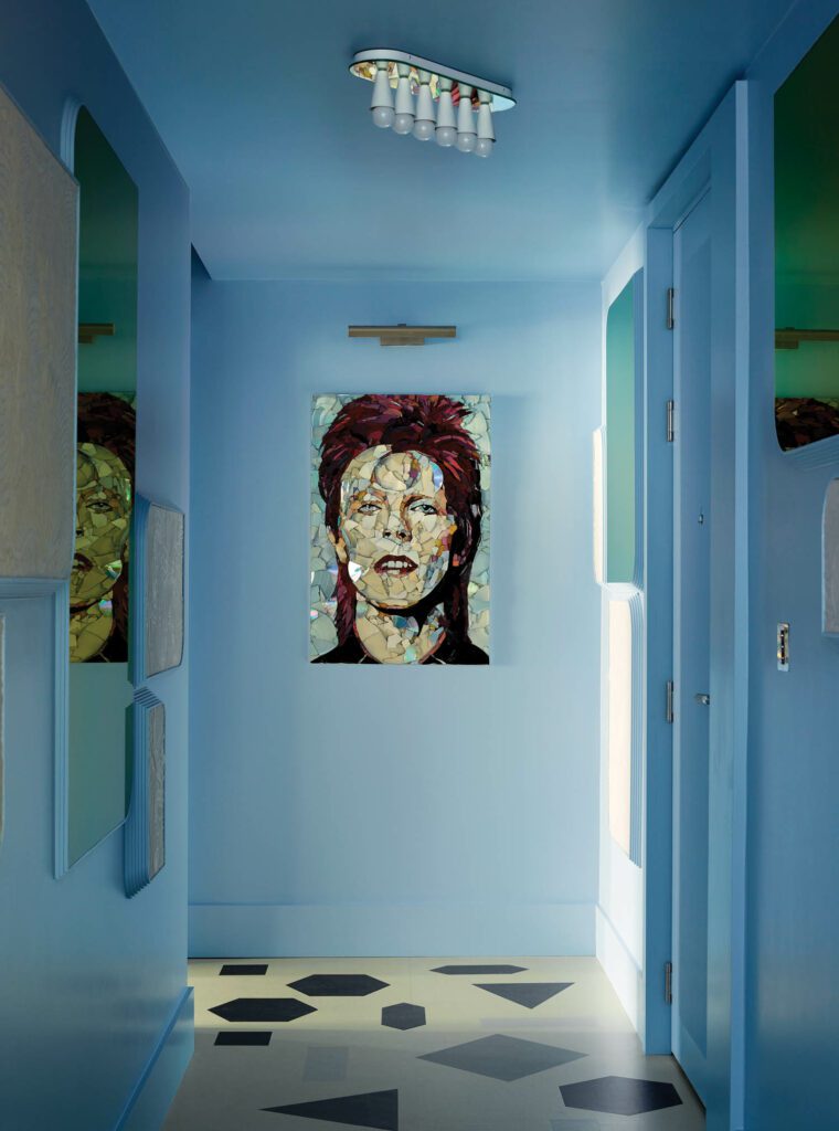 High-gloss blue paint backdrops the client’s treasured portait of David Bowie, one of the his favorite musicians, in the hallway.