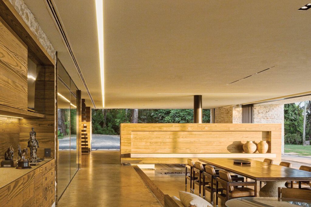 The entertainment pavilion’s sand-plastered ceiling, carbonized-pine paneling, burnt-concrete flooring, and rough-stone walls bring earthy tones and textures inside. 