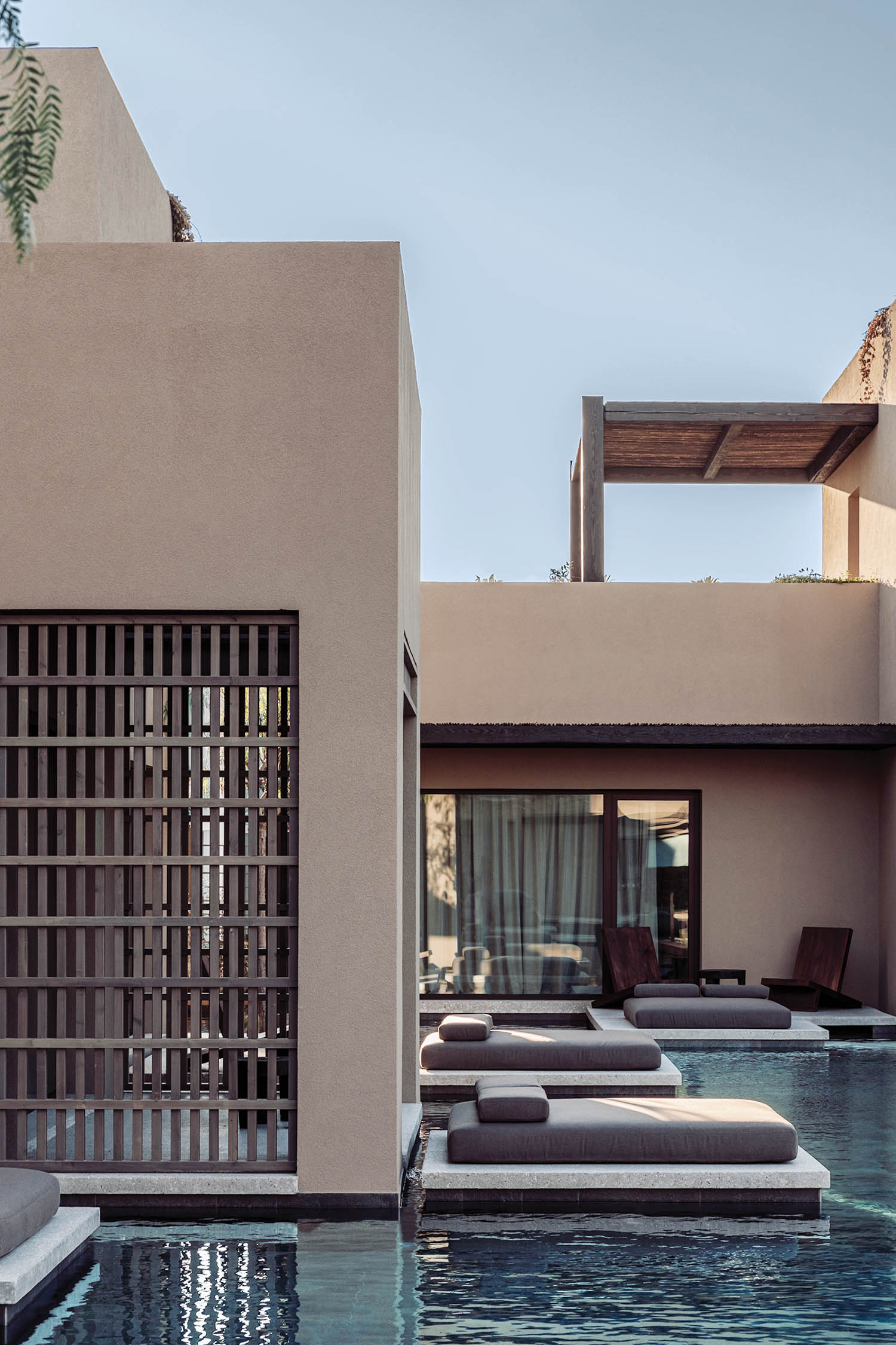 loungers in front of the pool and bedrooms at Casa Cook Samos