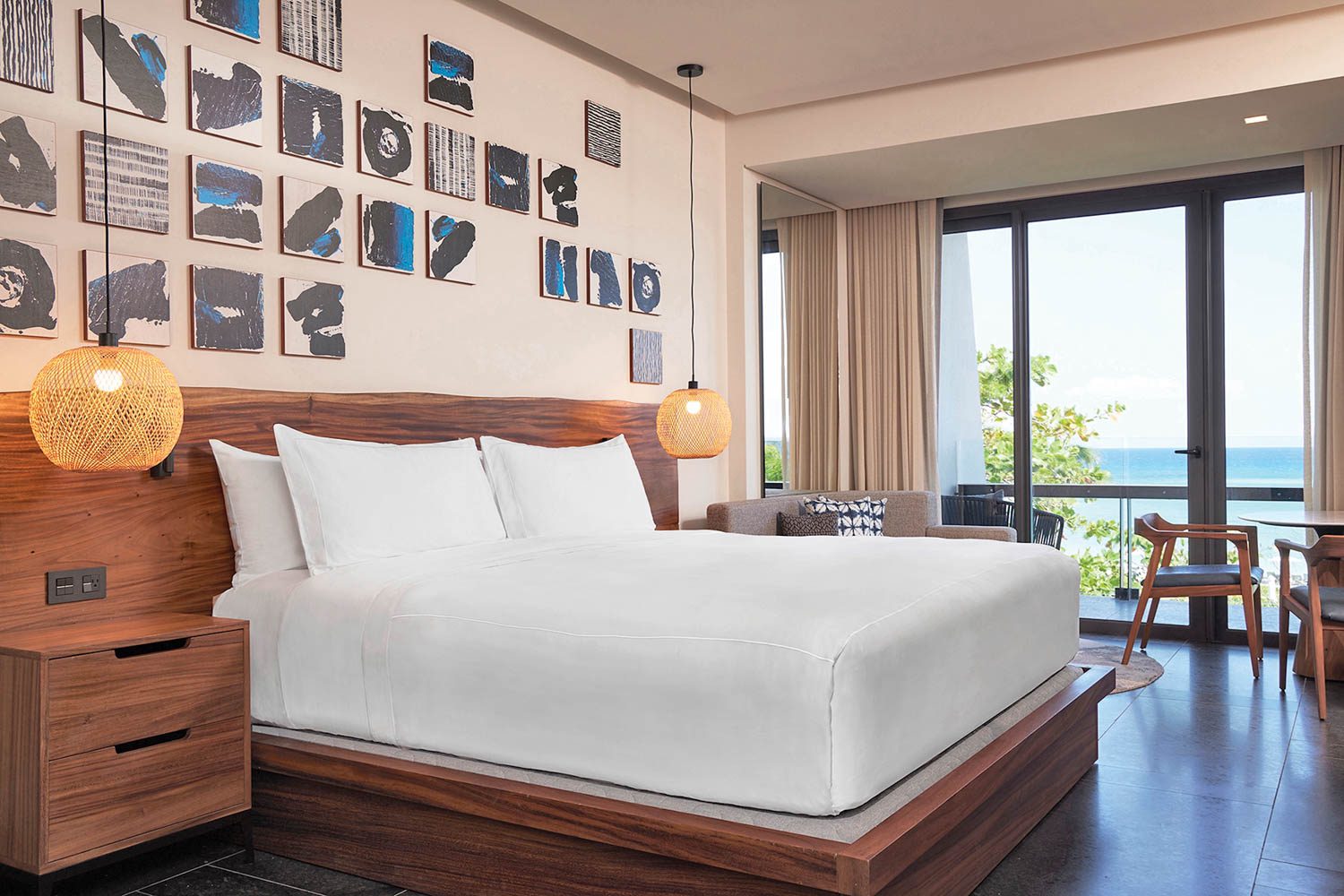 a guest bedroom with hanging pendant lights on either side of the bed