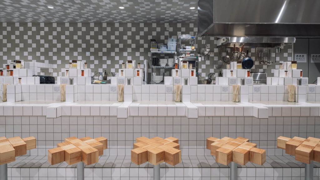 white block tiles form a countertop and zig zag grey tiles make up the backsplash