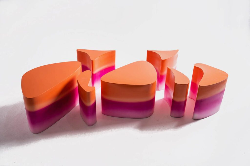 small modular stools and tables in a pink and orange gradient