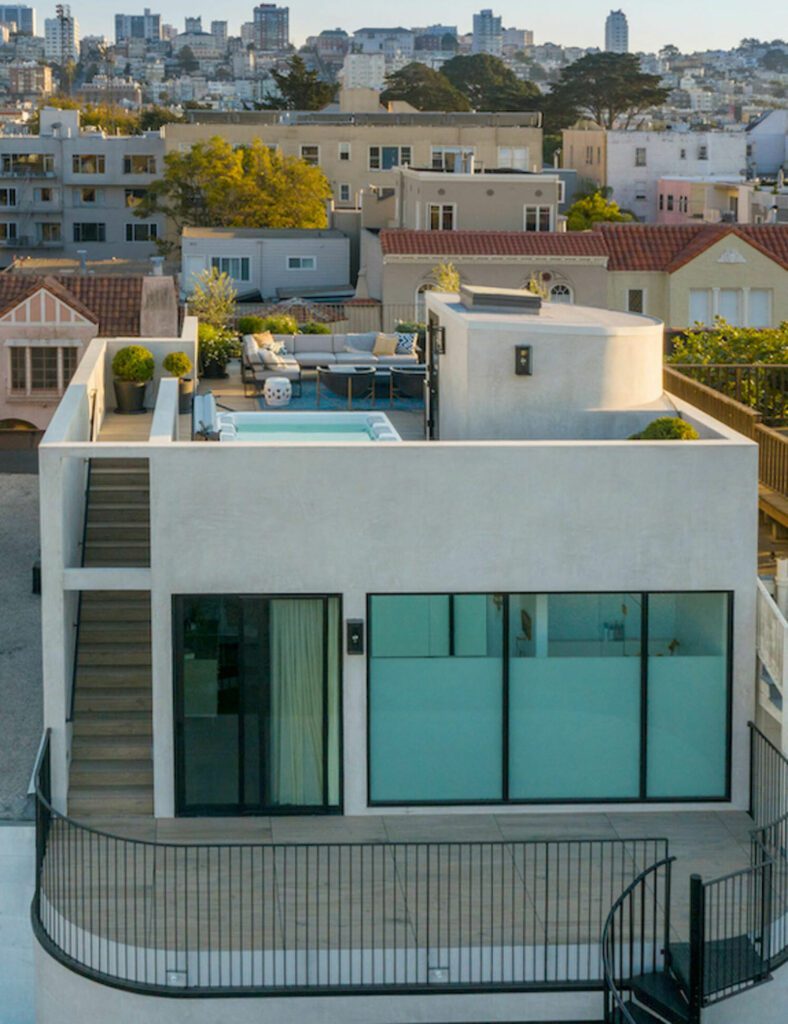 Large glass walls surrounding the home's back exterior let natural light into the space.