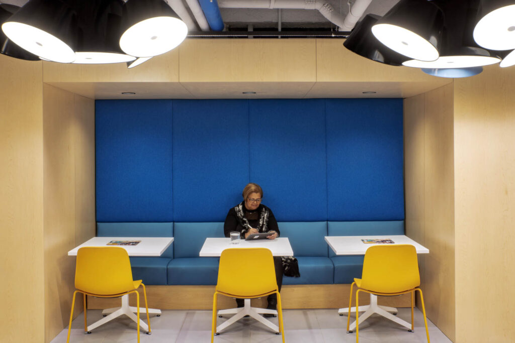 yellow seating in front of a blue bench seating in a cafe