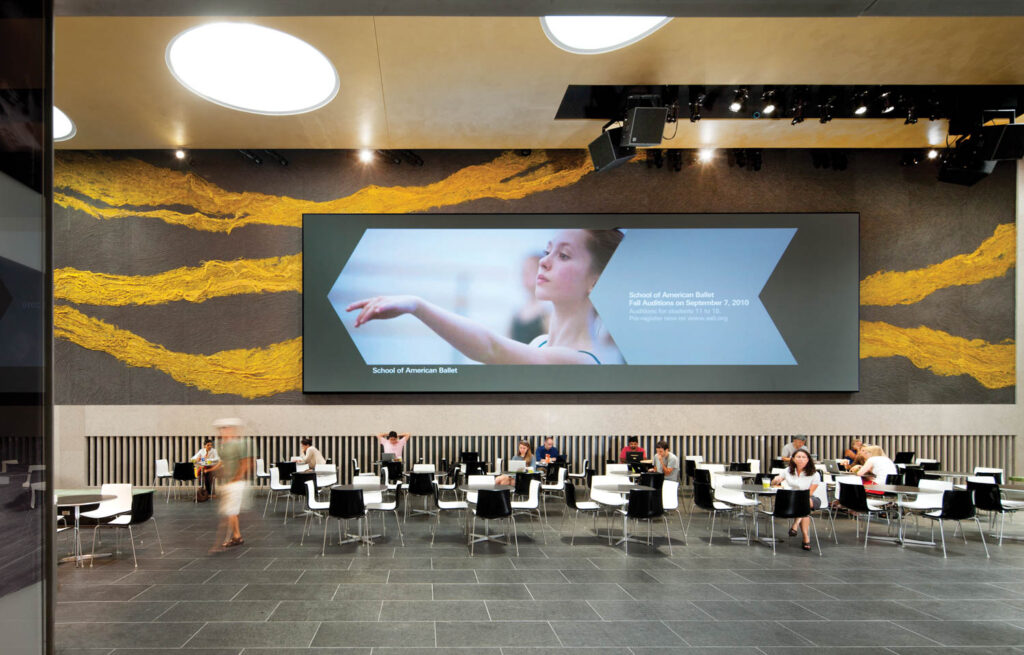 a yellow and gray felt 97-foot-long installation in the David Rubinstein Atrium at New York’s Lincoln Center