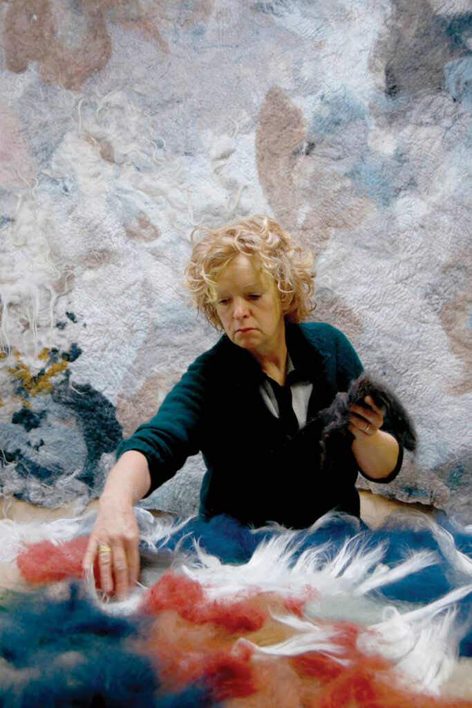 Claudy Jongstra in her studio in Spannum, Netherlands, composing an artwork with wool 