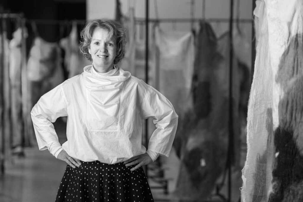 The founder of Studio Claudy Jongstra in front of her monumental sculptural installation Woven Skin