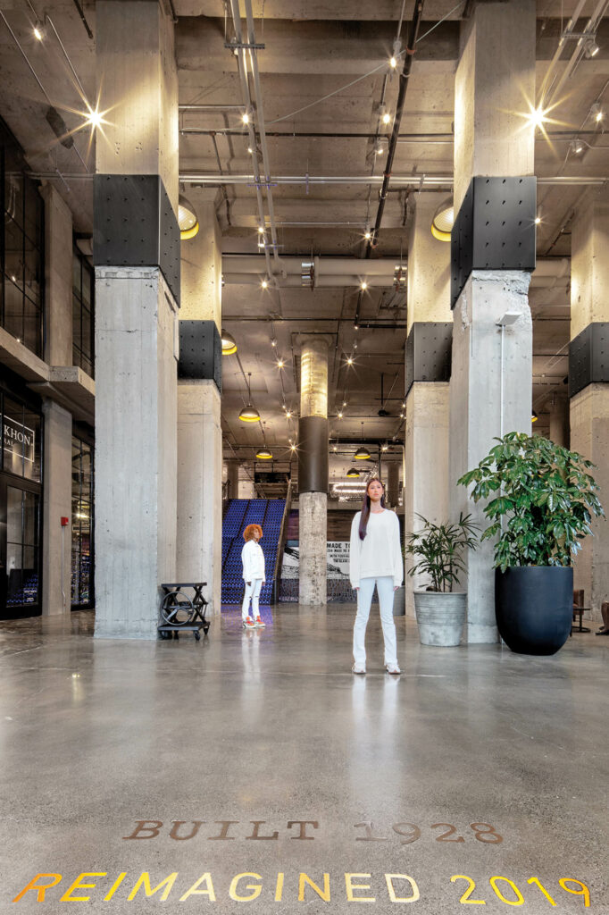 a lobby's concrete floor with engraved text of "Built 1928, Reimagined 2019"