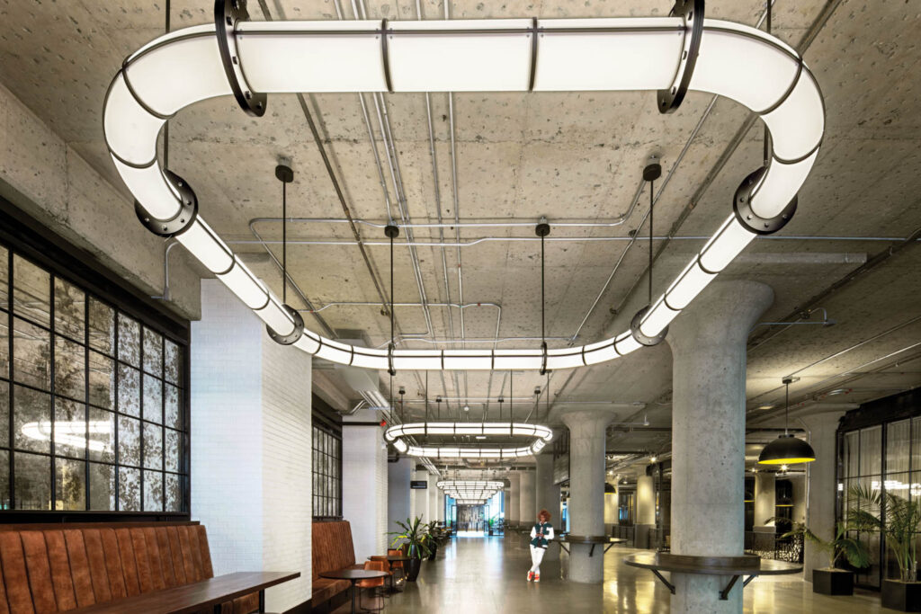 custom light fixtures reminiscent of tubing running through the warehouse