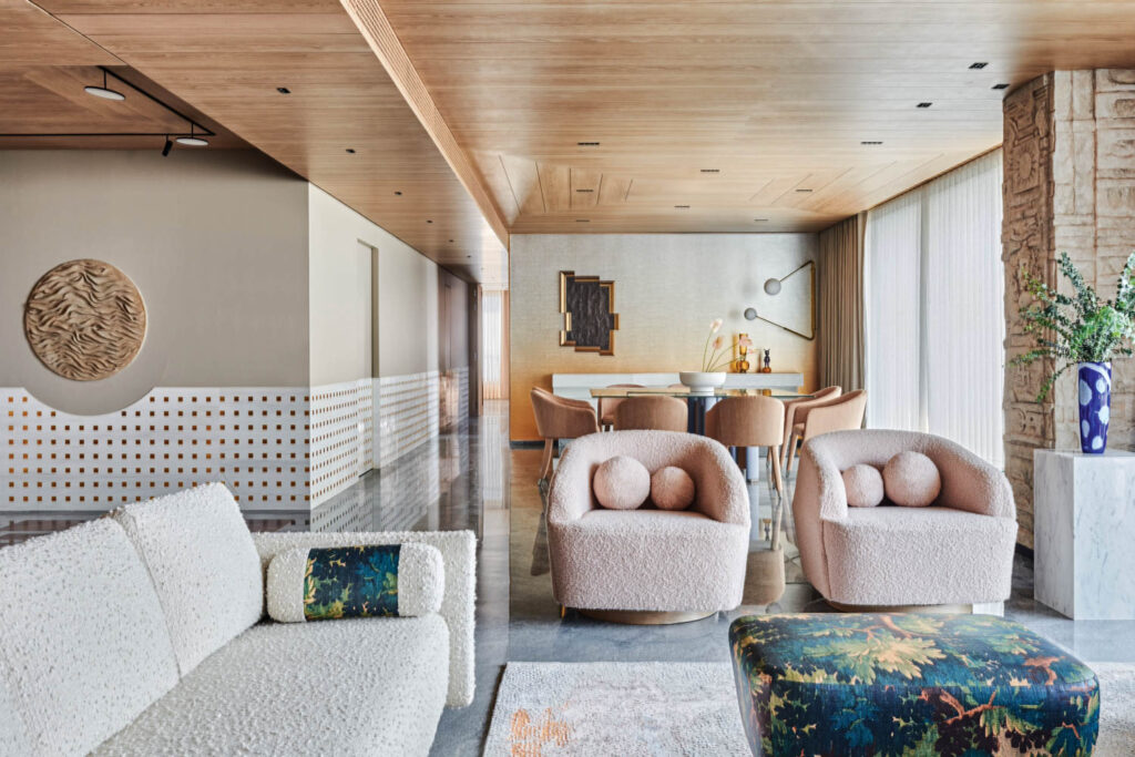 pink boucle chairs and a white boucle couch in the living room of a Mumbai home