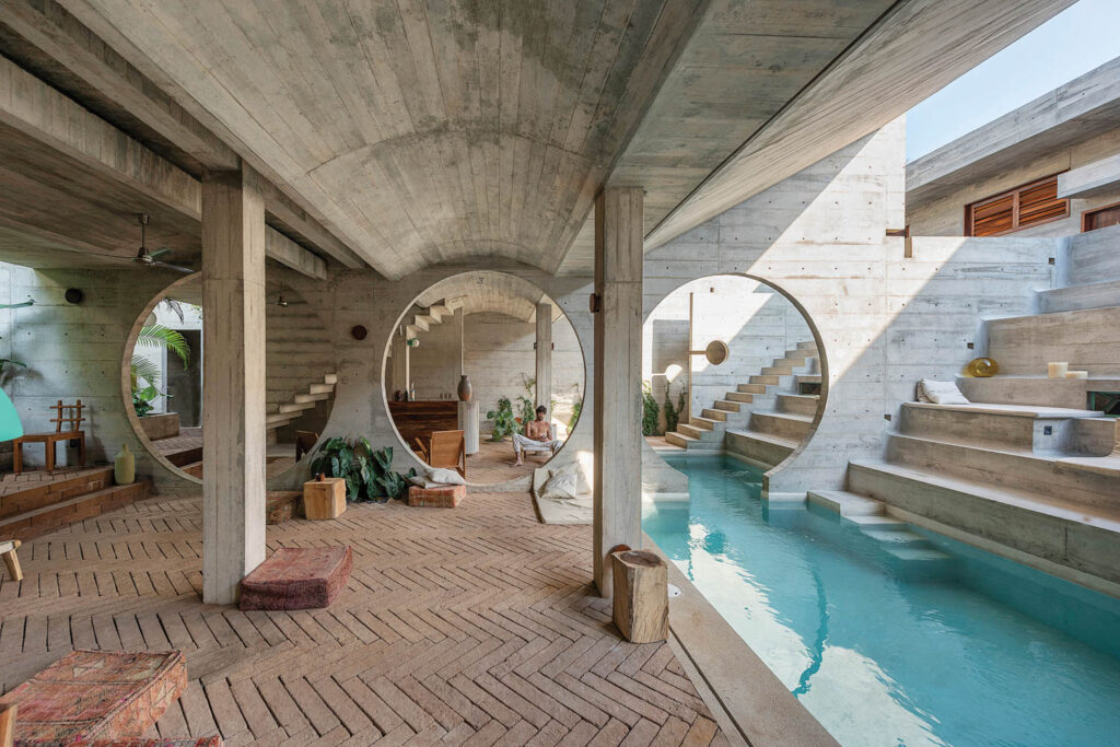 three circle cutouts in the wall of an Oaxaca hotel with a pool