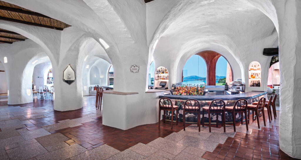 white stone arches throughout a hotel restaurant overlooking the water