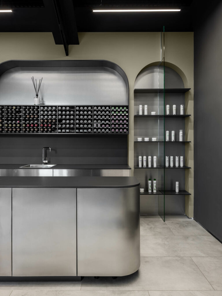 The hair studio design includes stainless steel countertops like his hair washing sink.