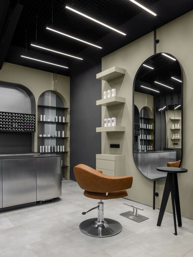 The hair salon design includes curved mirrors that create an illusion of depth. 