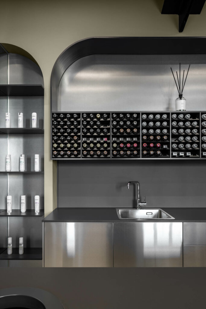 A stone countertop with stainless steel furnishings nods to those in restaurant kitchens. 