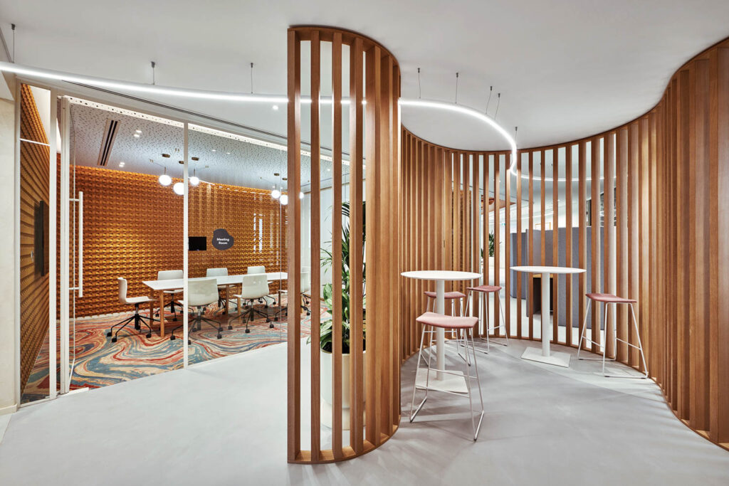 Vertical oak slats partition off a corridor’s work area