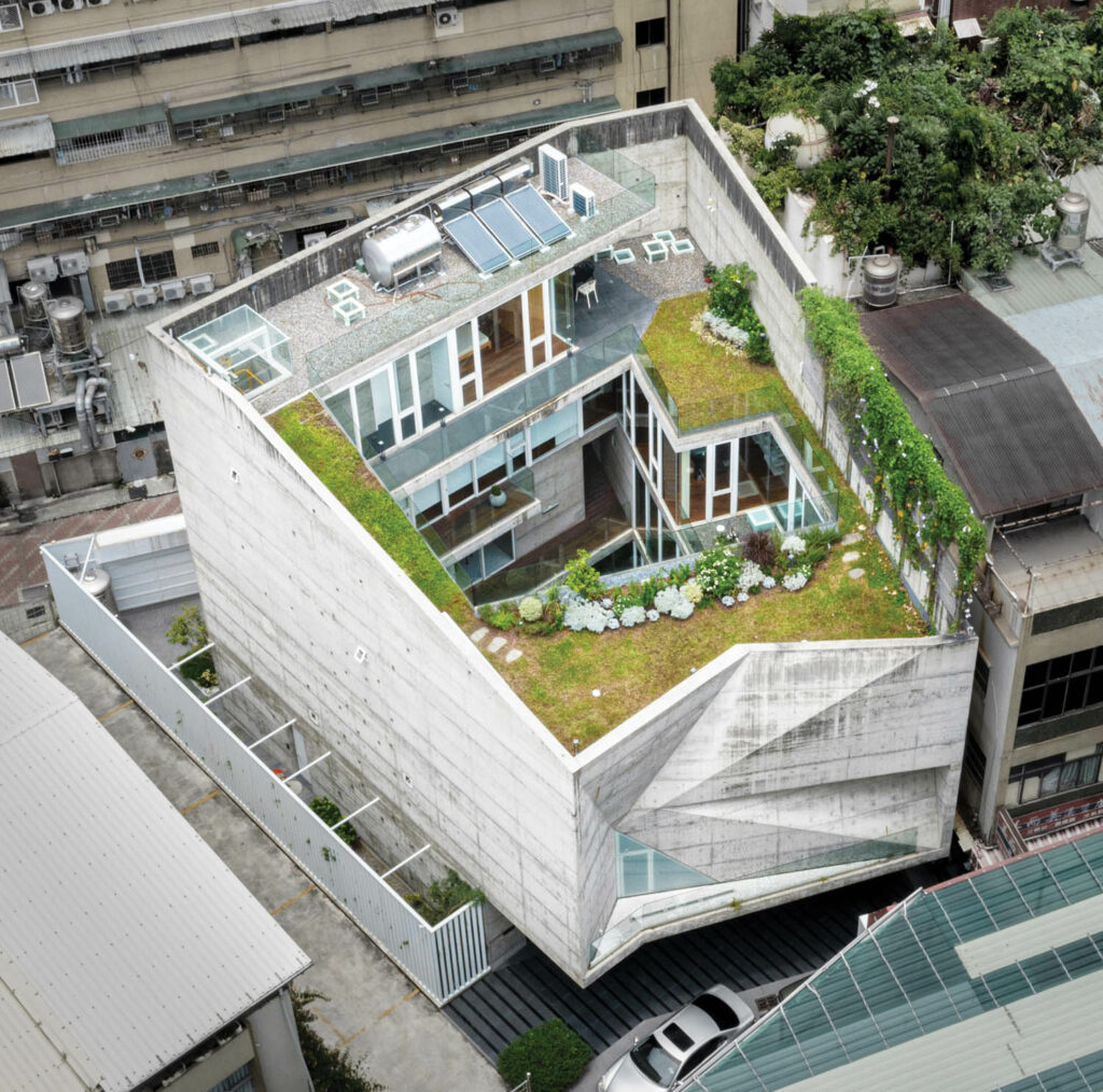 an aerial view of a rooftop covered in greenery