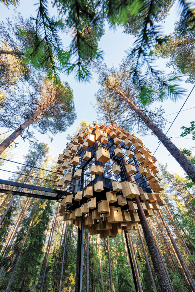 a round boutique hotel covered in birdhouses