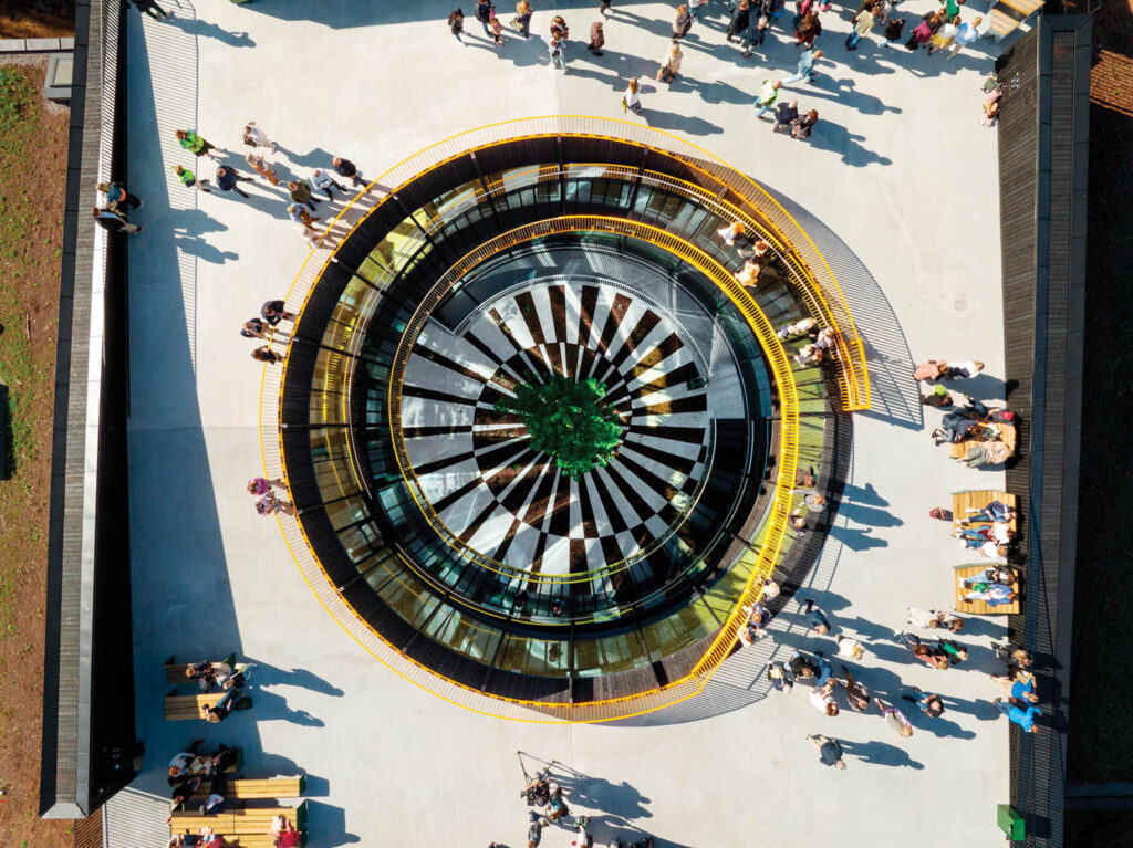 an aerial view of a spiral staircase that leads to the top of The Plus