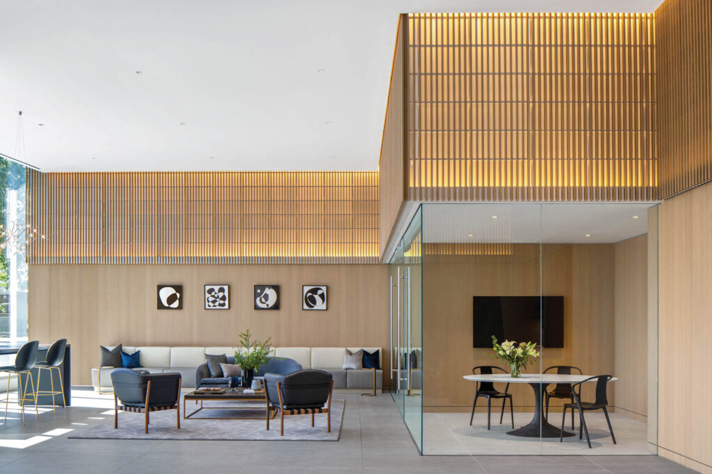 a lounge area with light wood walls and various seating options