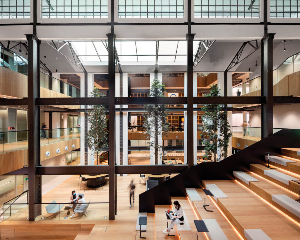 an amphitheater of stairs flanked by a glass wall