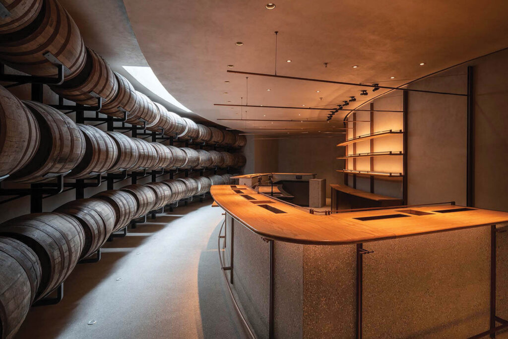 whiskey barrels in rows in front of a bar