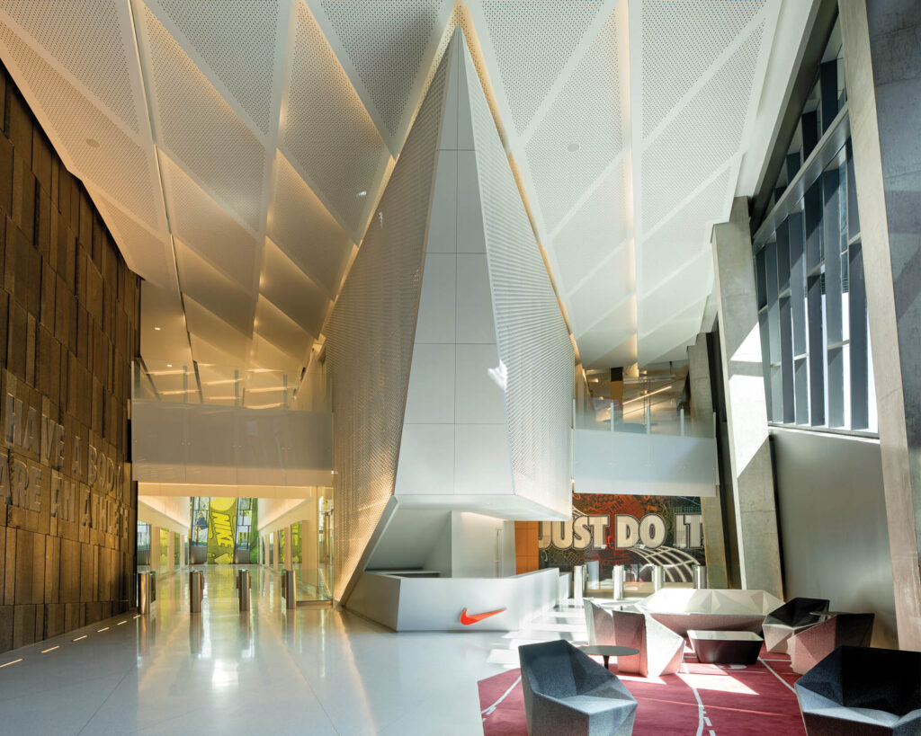 In the reception area of the office, Nike's tagline graces the back wall with an orange Nike swoosh on the reception desk.