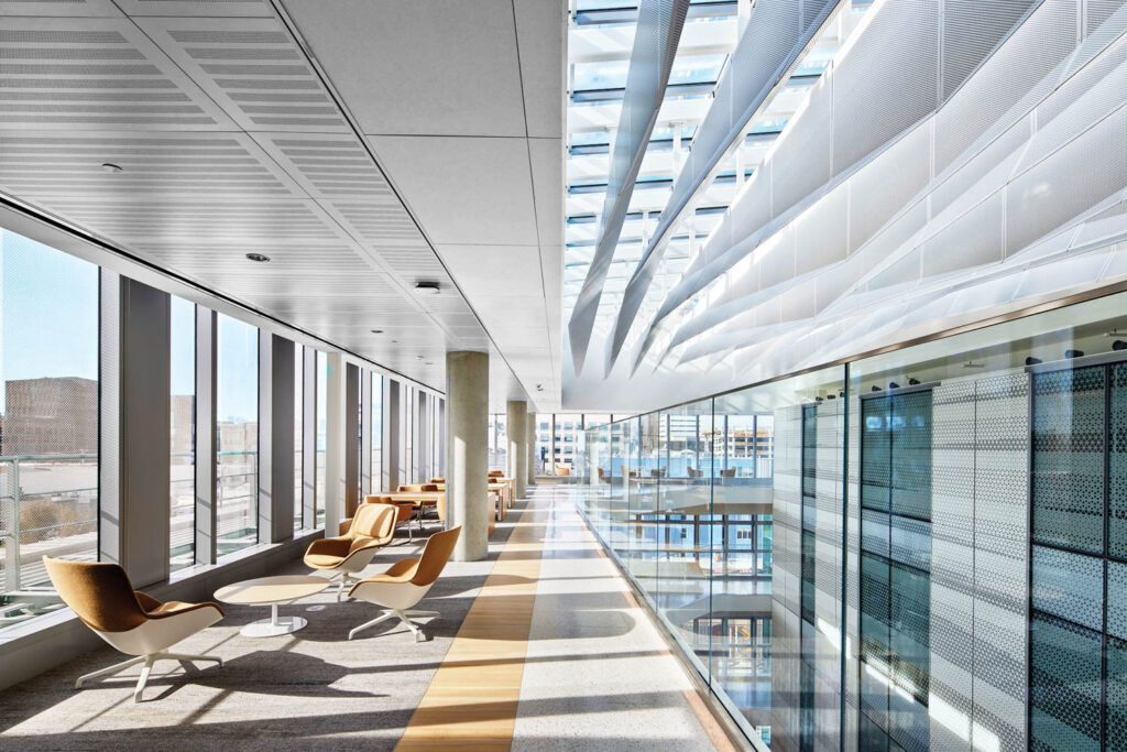 a lounge seating area next to floor to ceiling windows